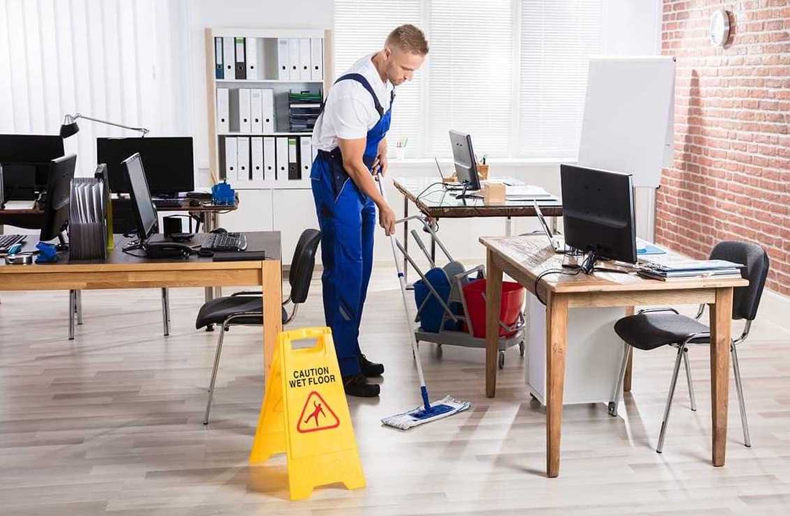 the man cleans the office, mops the floors