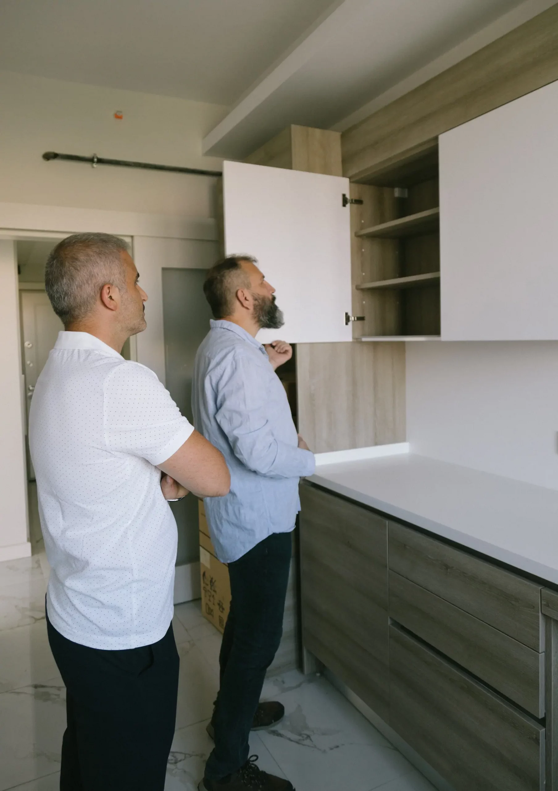 Home inspection: 2 men are inspecting a kitchen
