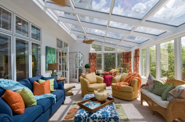 large sunroom with big yellow seats and blue sofa