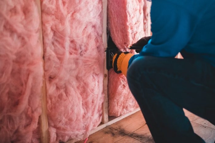 a worker is installing an insulation